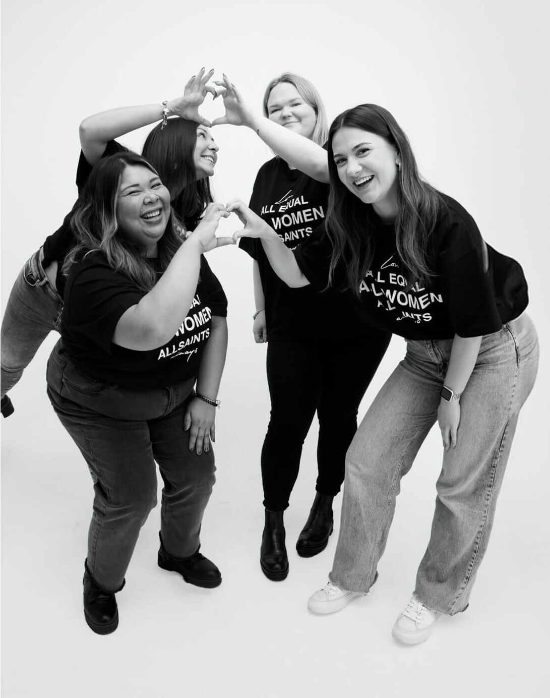 Photograph showing women standing next to each other wearing print AllSaints t-shirts.