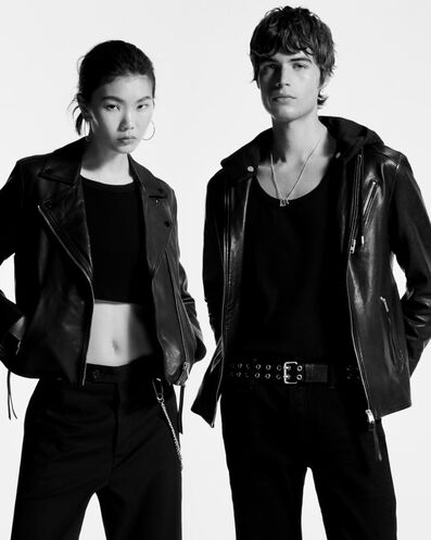 Man and woman wearing black leather jacket & black trousers.